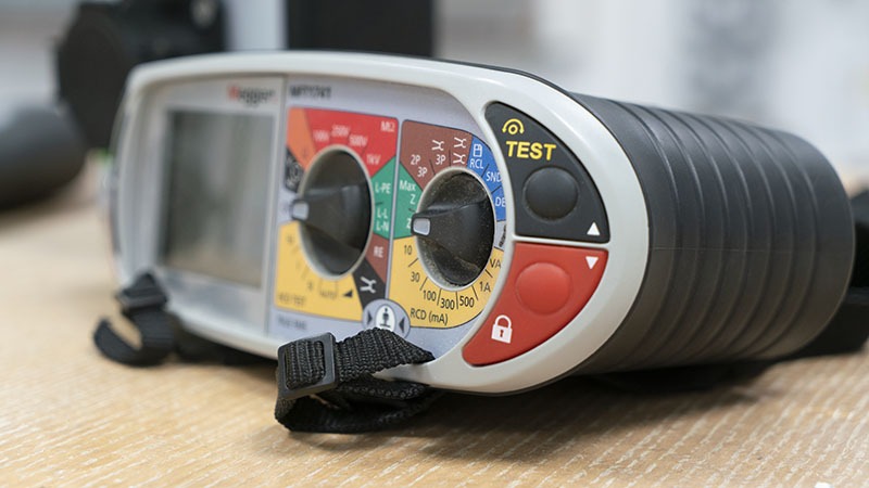 Electrical installation testing instrument on a workbench